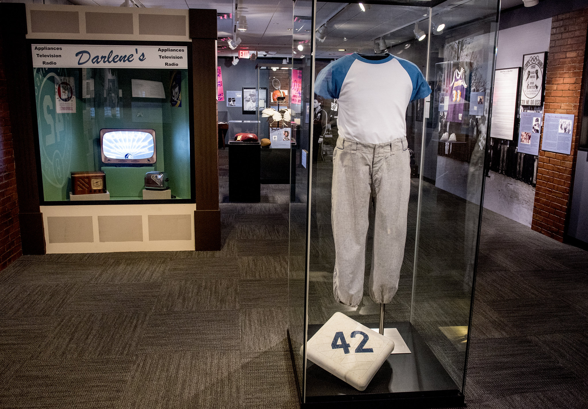 A view of the Jackie Robinson display case, which has his game-worn pants and a base with the number 42 on it inside, that are part of the "Get in the Game" exhibition at the LBJ Library.